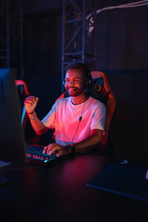 Man in White Shirt Sitting in Front of a Computer