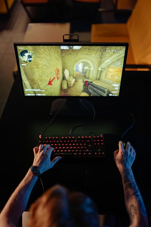 A Person Playing a Video Game in a Computer · Free Stock Photo