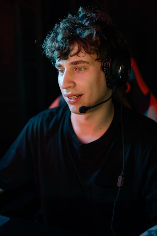 Close-Up Shot of a Man in Black Shirt Wearing Headset