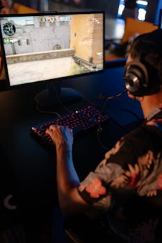 A young man in a floral shirt is focused on a gaming session, highlighting immersive entertainment.