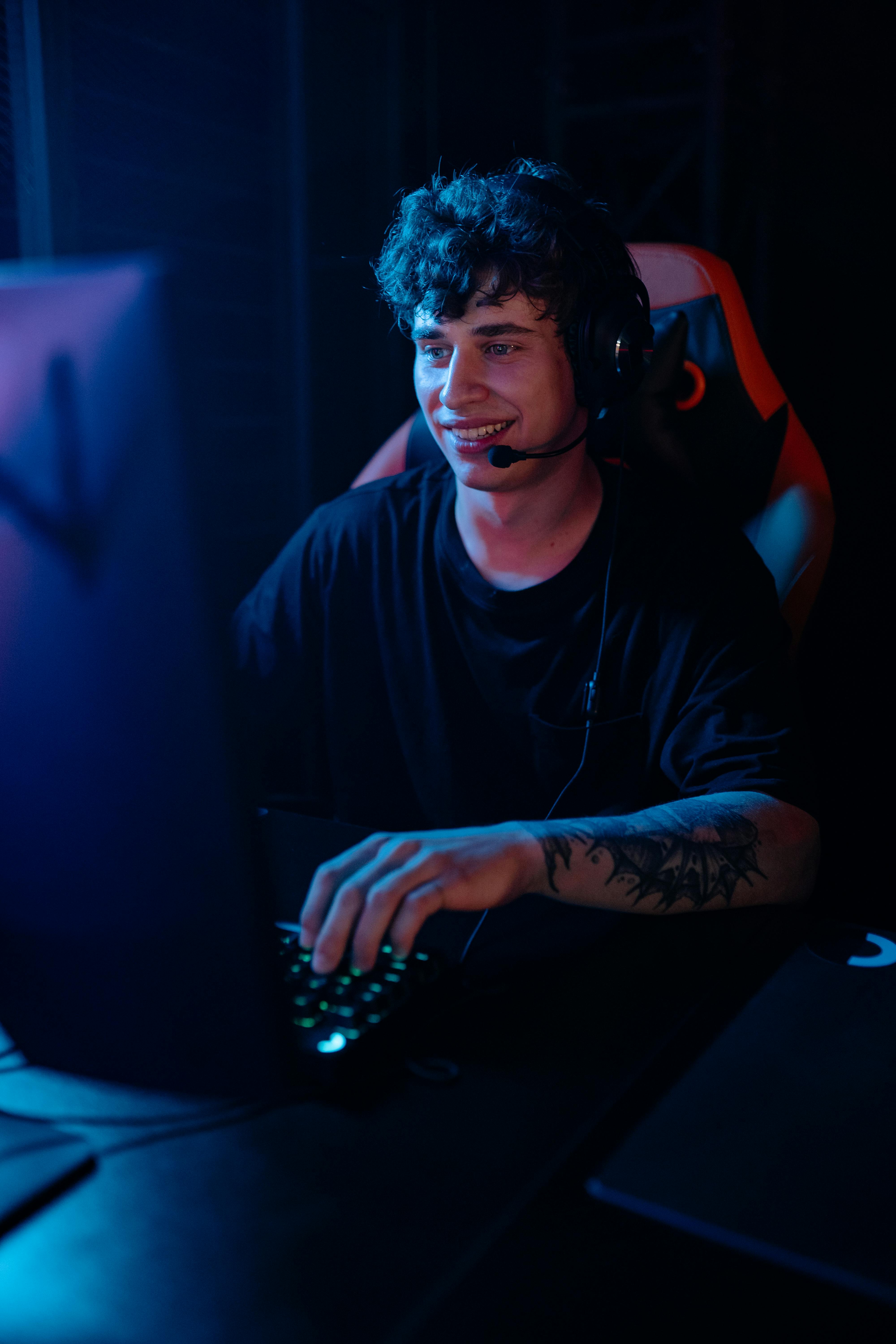 a man in black shirt playing video games on computer