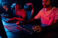 Man in Red Shirt Using Computer