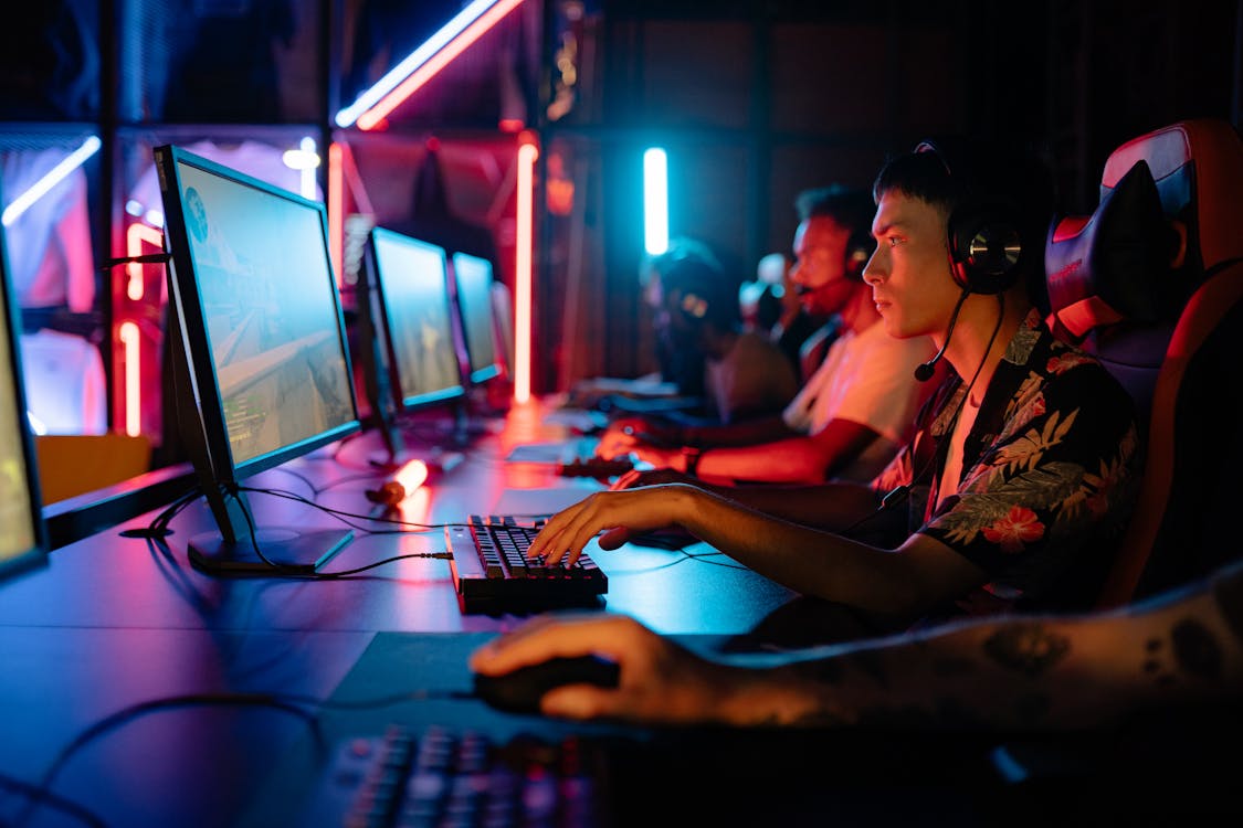 Free Men Gaming on Personal Computers Stock Photo
