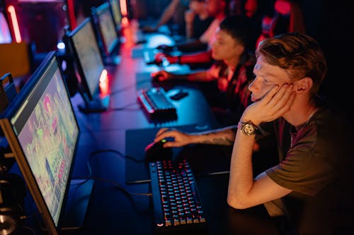 Free A Team Looking Bored While Playing Online Games Stock Photo