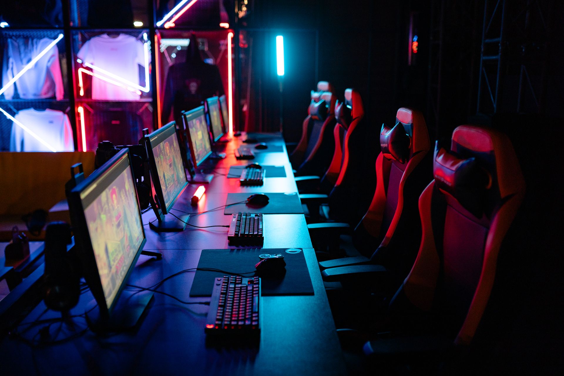 Competitive esports gaming setup with RGB lighting and multiple monitors