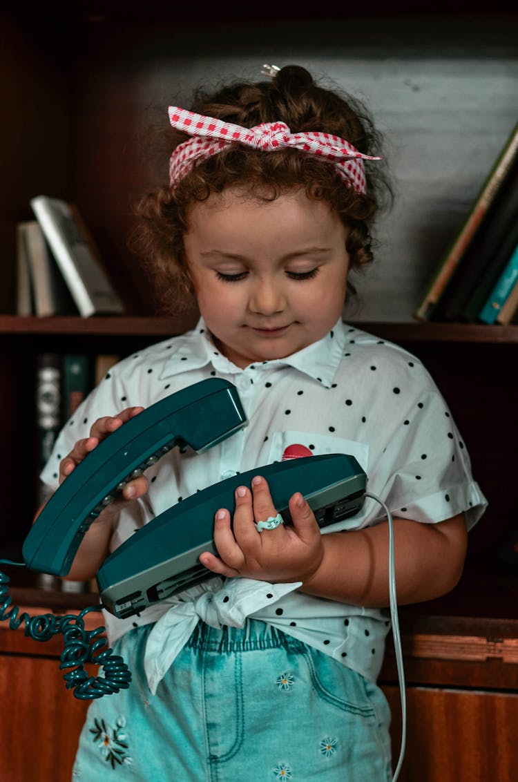 A Girl Holding A Telephone