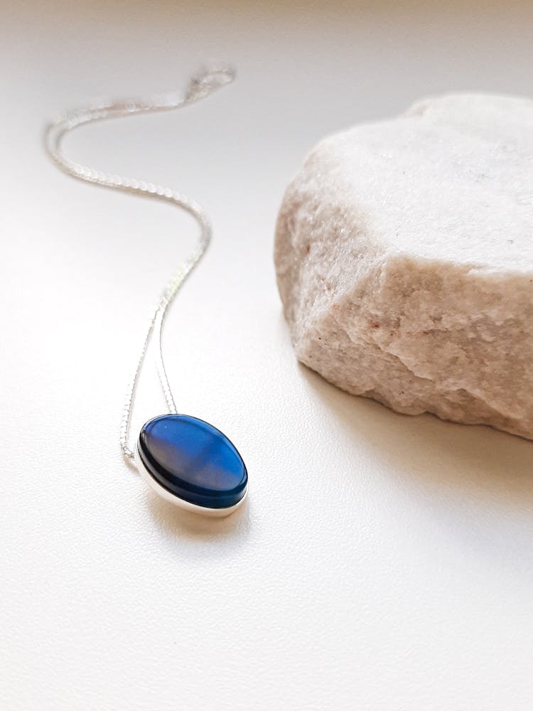 Pendant With Blue Gemstone Near Crystal Piece