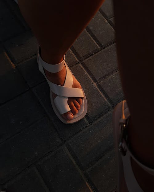 A Person Wearing White Leather Sandals