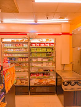 Refrigerated shelves stocked with various products in a convenience store setting. Bright and inviting.