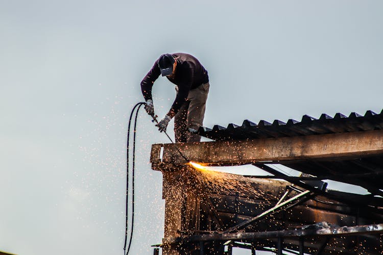 A Man Working On The Roof