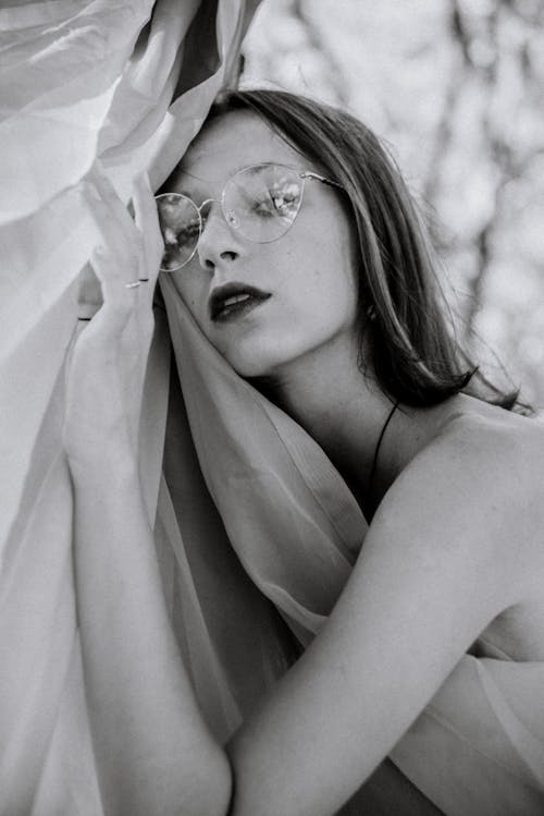 Free Woman Wearing Eyeglasses Holding a Fabric Stock Photo