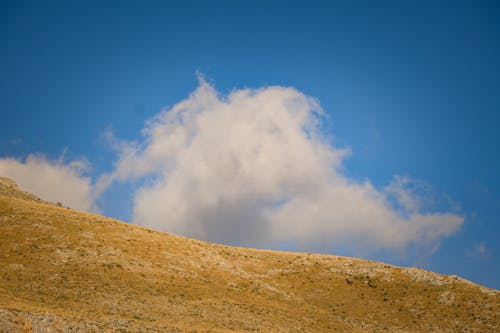 Free White Clouds Over a Mountain Stock Photo