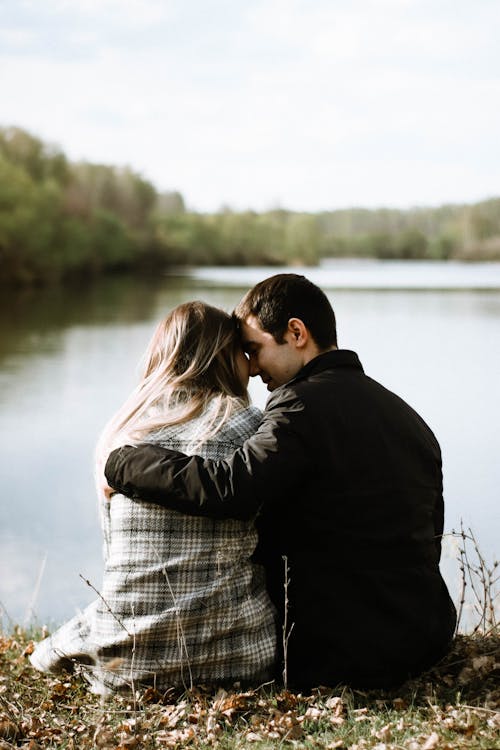 Man and Woman Kissing Near a Lake