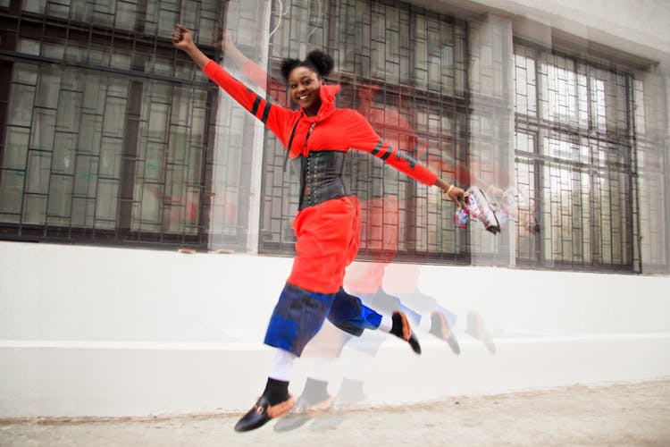 Woman Wearing Red Dress Jumping