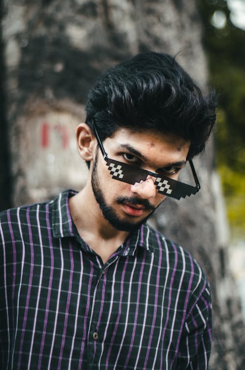 A Man in Checkered Shirt Wearing Sunglasses