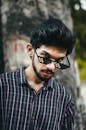 A Man in Checkered Shirt Wearing Sunglasses