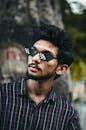 Man in Checkered Button Up Shirt Wearing Black Sunglasses