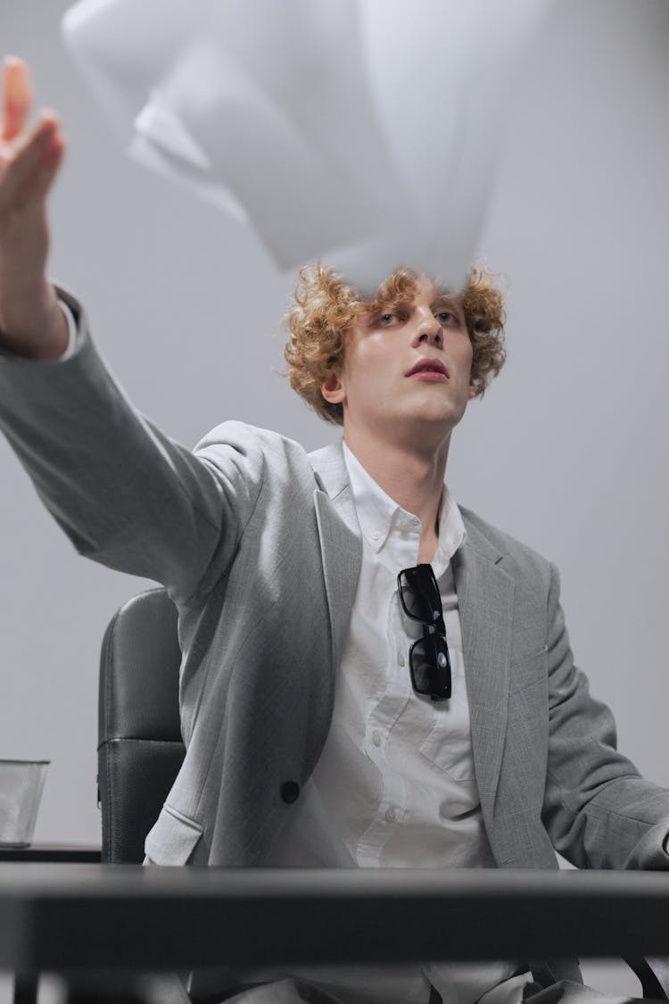 Blond Man Throwing Papers 