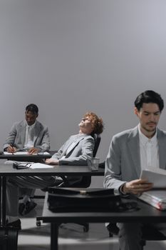 Professionals in office experiencing work fatigue, highlighting burnout.