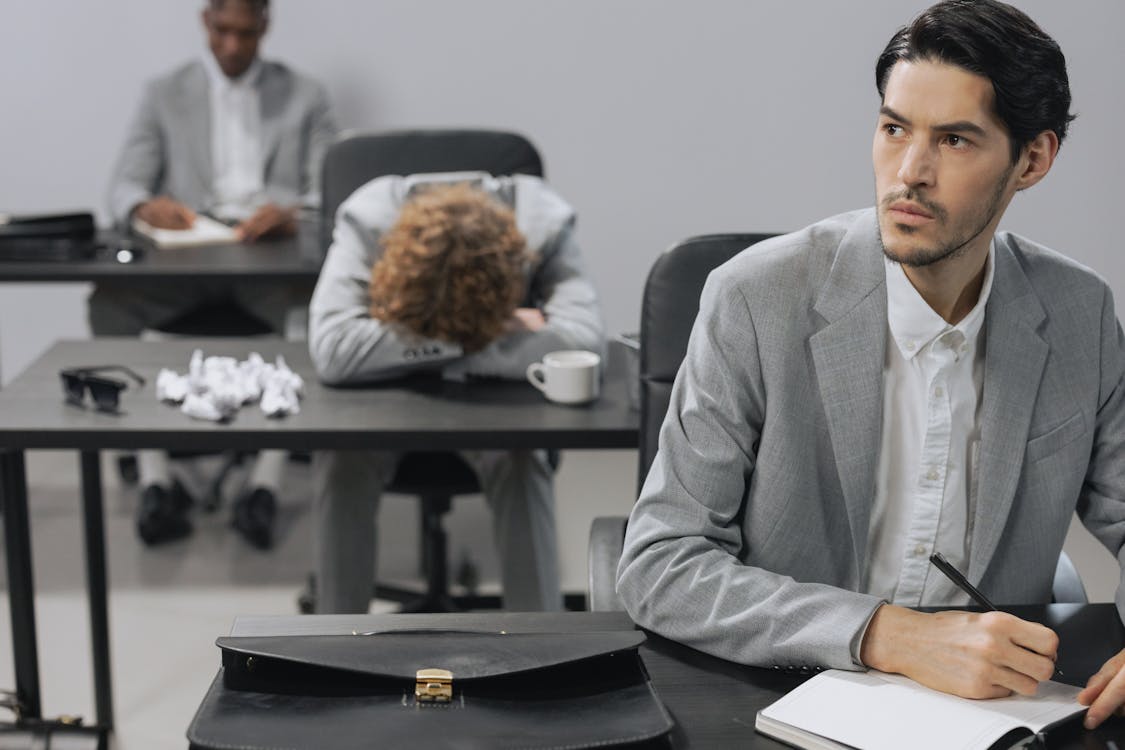 Free A Man in Gray Suit Jacket Sitting at the Table Stock Photo