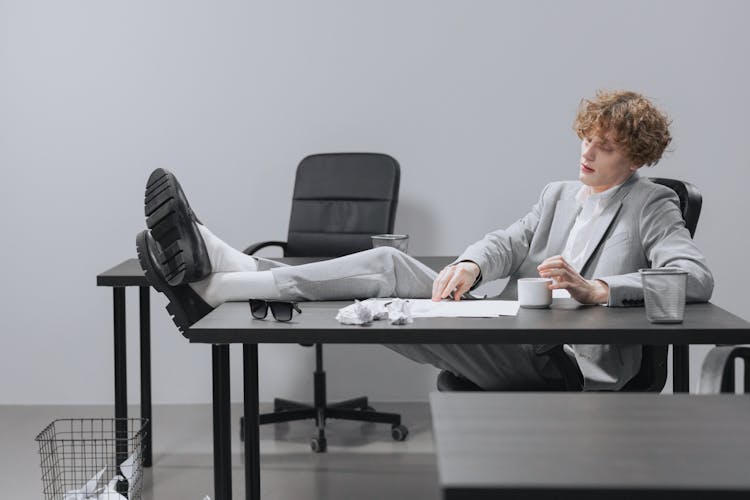 Man Resting His Legs On The Table 