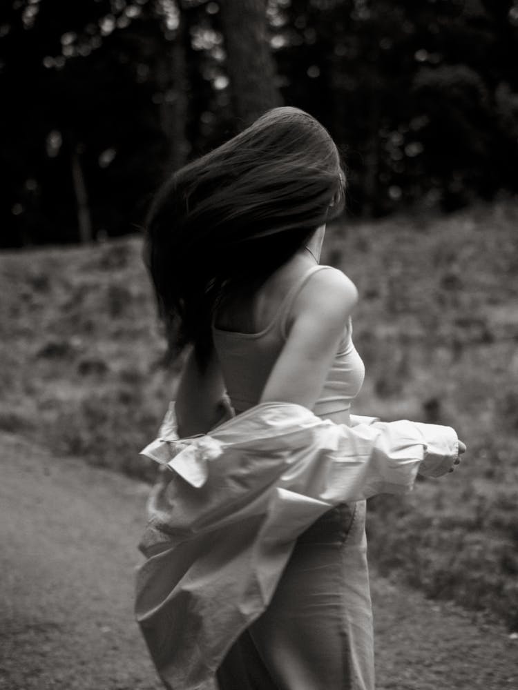 Grayscale Photo Of Woman Turning Back 