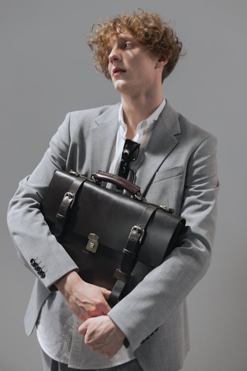 Free Man in Gray Suit Holding a Black Leather Bag Stock Photo