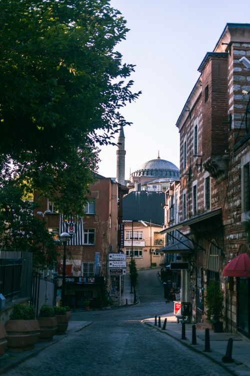 Free A narrow cobblestone street in Istanbul leading to the iconic Hagia Sophia dome, showcasing historical architecture. Stock Photo