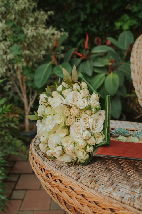 A Bunch of White Roses on a Woven Chair