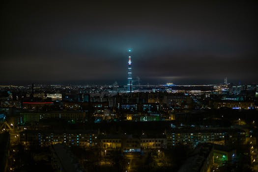 A stunning aerial view of Saint Petersburg at night, highlighting the radiantly illuminated cityscape and iconic television tower.