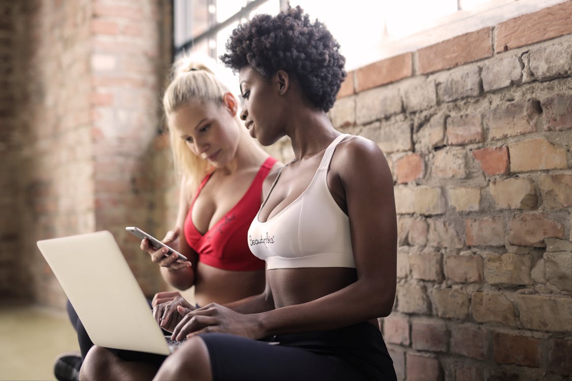 Free Two Woman Wearing Red and White Sports Bras Stock Photo