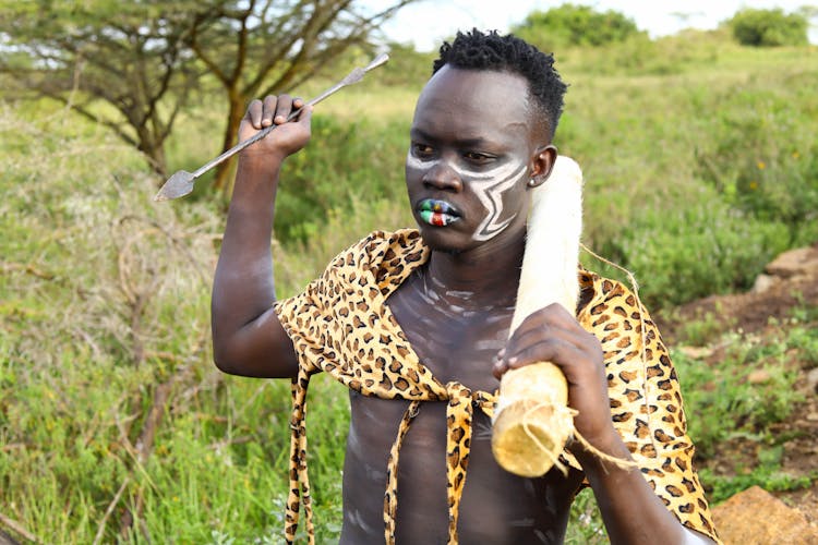 Man With Traditional Tribal Body Painting And Arrow