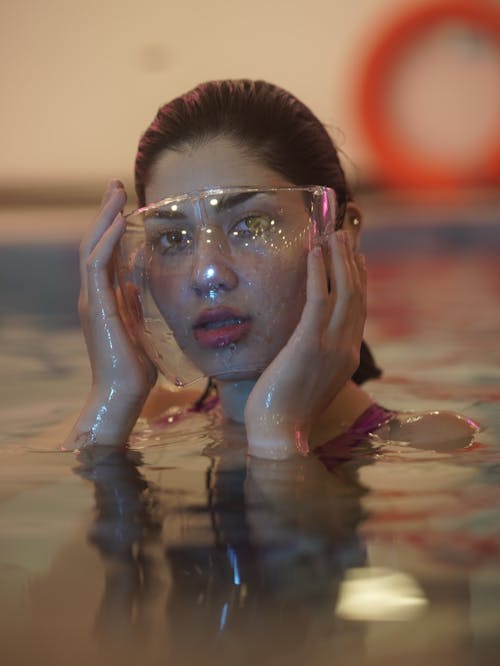 A Woman Wearing a Face Shield in the Swimming Pool