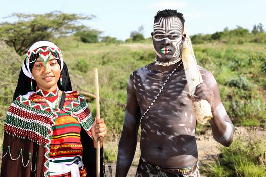 Man and Woman Wearing Tribal Clothing and Body Paintings