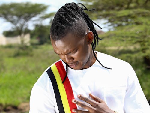Man Touching Uganda National Colors on T-shirt with Respect
