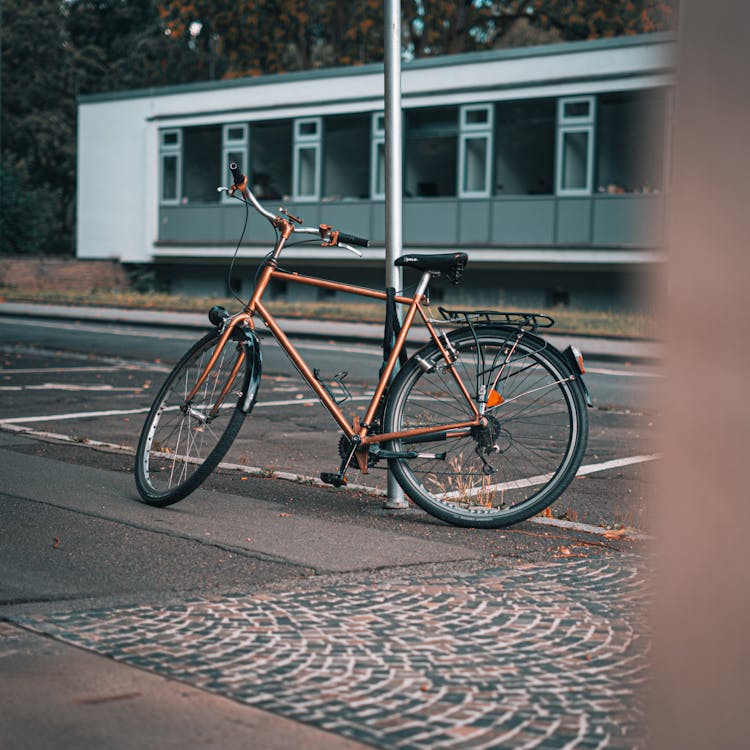 A Bicycle Leaning On A Metal Pole