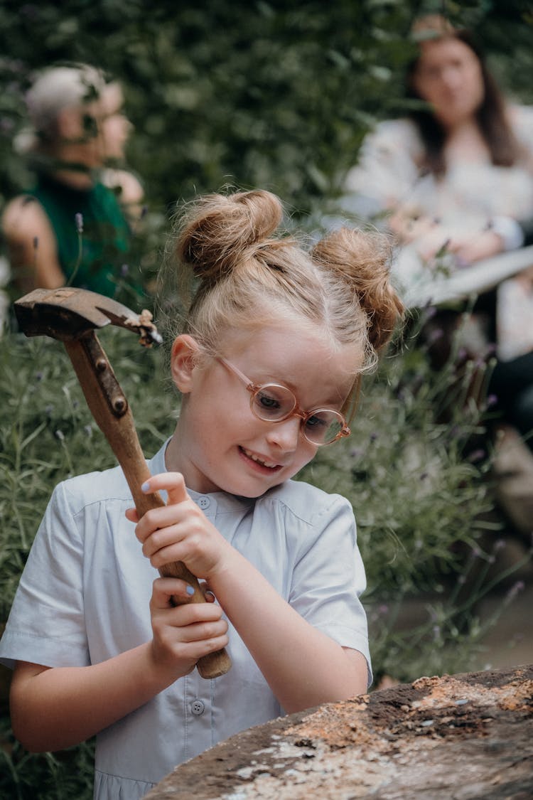 A Girl Holding A Hammer