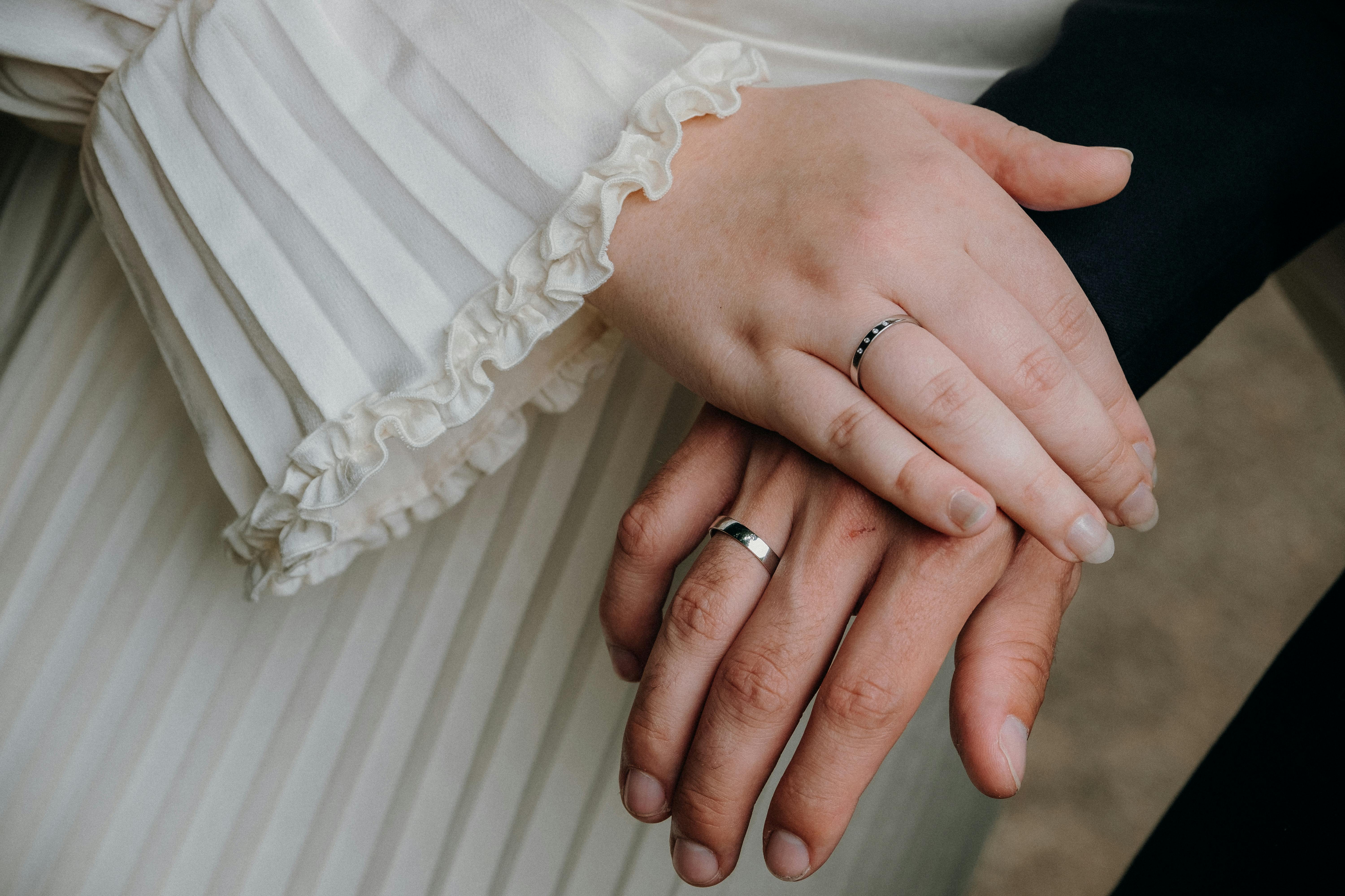 Holding hands wedding on sale rings