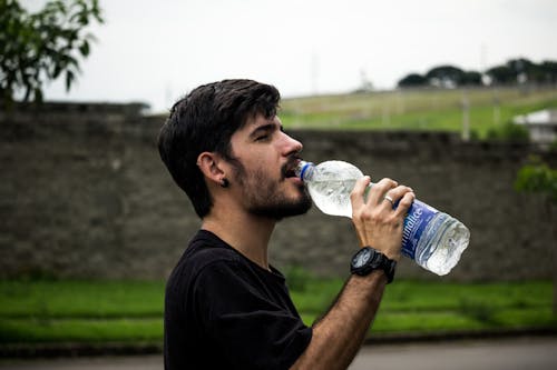 Man Wearing Black Shirt Drinking Water