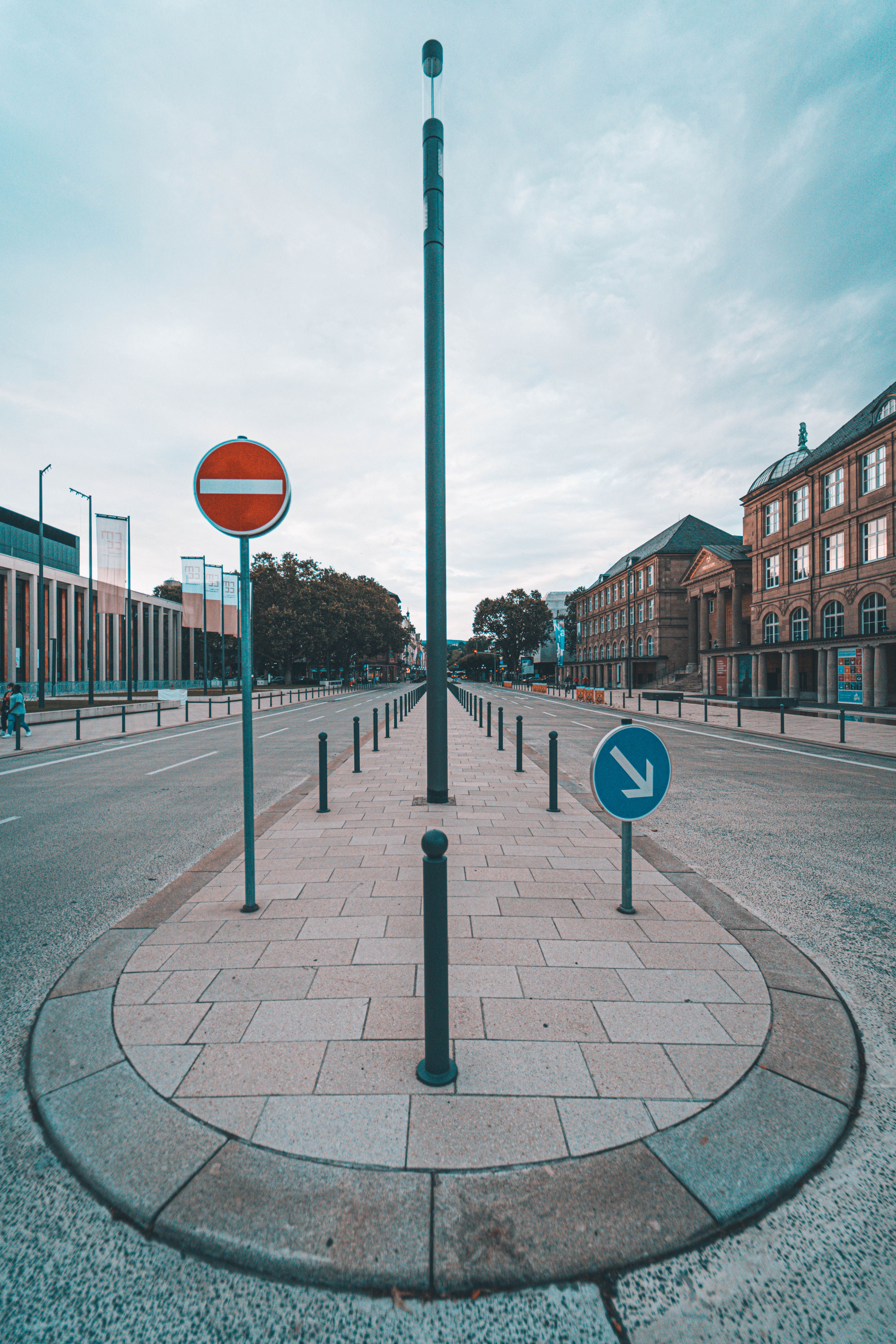 A symmetrical urban street view in Wiesbaden, Germany featuring road signs and historic architecture.