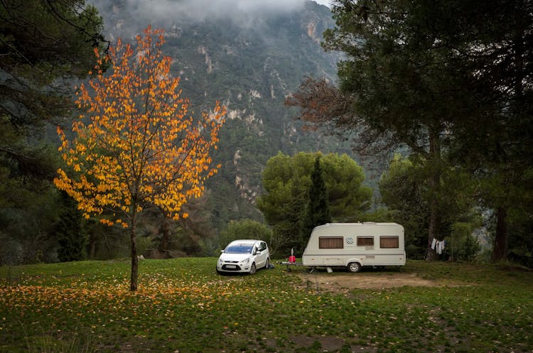 Car With A Camper Trailer In Mountains 