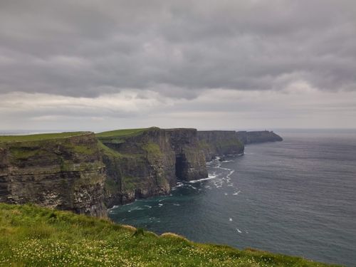 Free Explore the breathtaking Cliffs of Moher under a dramatic overcast sky, showcasing rugged natural beauty. Stock Photo