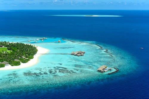 Aerial Shot of Island Surrounded by Blue Sea 