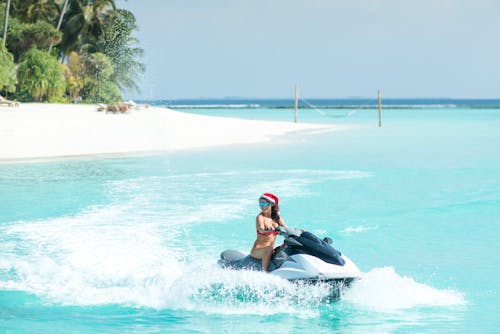 Free A Woman Riding a Jet Ski on the Sea Stock Photo