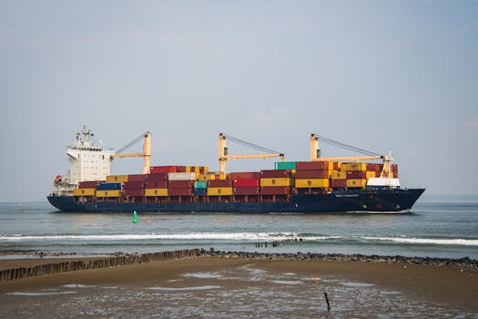 Cargo ship carrying colorful containers sails near Terneuzen, Netherlands