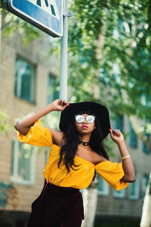 Free Woman in Black Hat and Yellow Top Taking Selfie Stock Photo