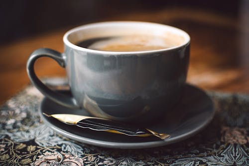 Free Gray Ceramic Cup of Coffee on Round Gray Saucer Stock Photo