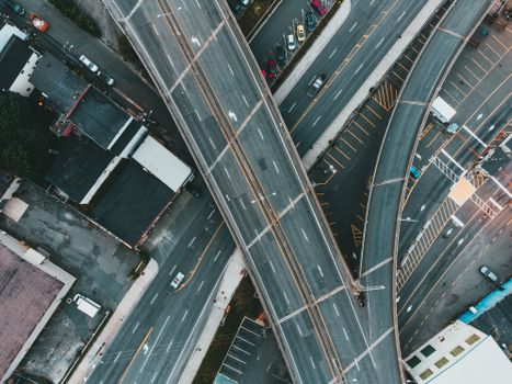 A top-down view of a busy urban expressway intersection with multiple lanes and flyovers.
