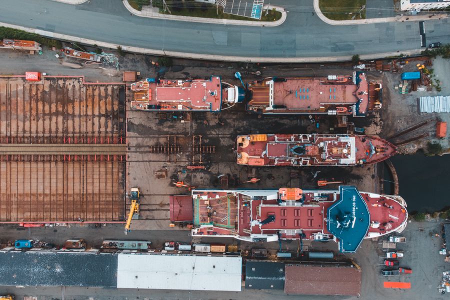 Aerial view of vessels and heavy equipment in a shipyard
