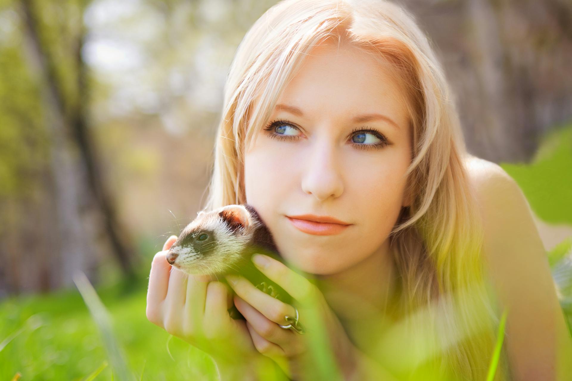 A Woman Holding a Ferret